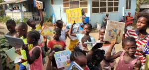 Distributing books at Annual Children's Outreach.