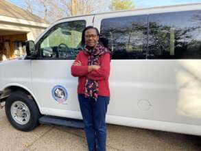 Dr. Hena with our newer 15 passenger CHW Van.