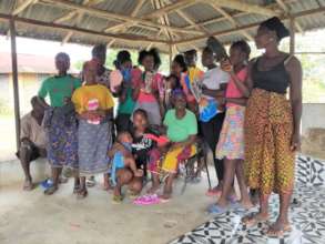 Village ladies receiving flip-flops