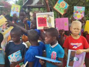 Children Receiving Books from Barrels of Love