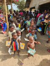 Village children receiving books.