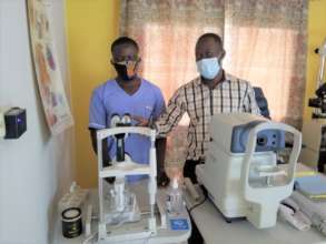 Dr. Douglas (plaid shirt) and Germenie Togba