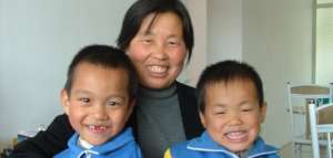 Liang Liang with his foster mother and brother
