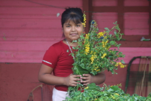 Girl with mustard plant