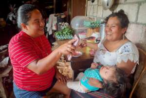 Team member, Candelaria, sharing Program resources