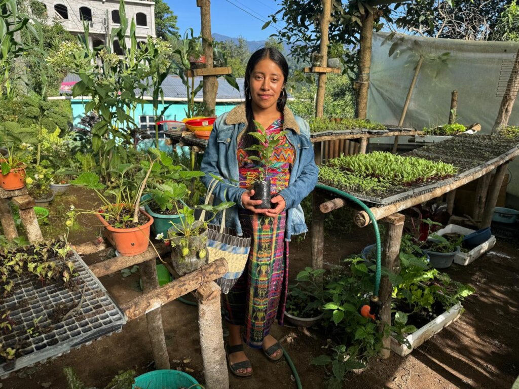 Collecting seedlings before planting her garden
