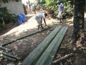 Using local materials: splitting bamboo for walls