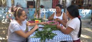 Sonia with sisters preparing chipilin