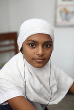 A beautiful young girl learning to speak and hear.