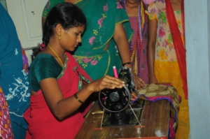 Adolescent girl is stitching cloths on machine