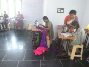 Girls are practicing cloths stitching on machine