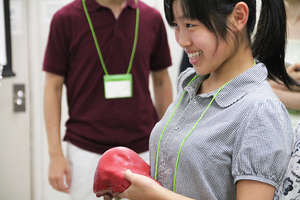 A participant holding a realistic model of liver