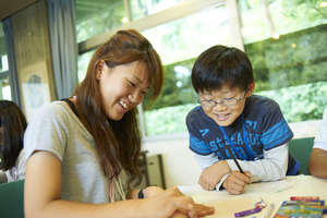 A student and a boy collaborate