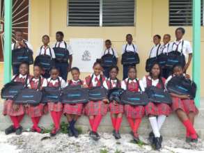 The kids of High Rock Primary with their bags.