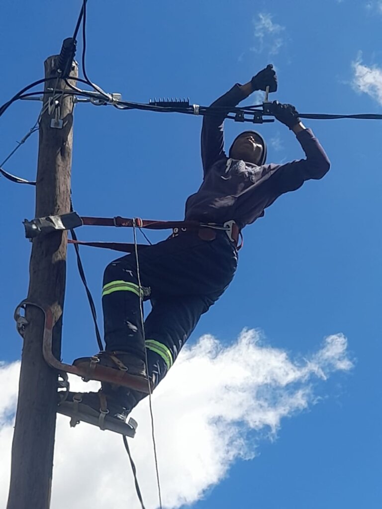 A OnePower lineman strings a new service line.