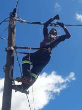 A OnePower lineman strings a new service line.