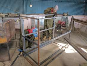 Welding the larger, easy-access battery box.