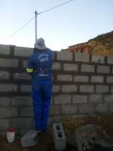 Professional Mason laying bricks for the new house