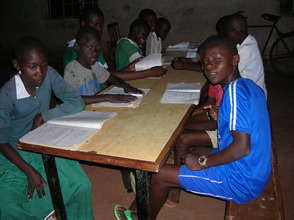 Children at Good Samaritan studying with new books