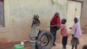 Children all happy for the hand pump