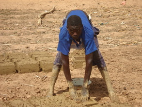 Sagiru making blocks from mud