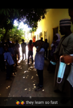 Student volunteer showing how to wear a face mask