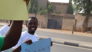 Aminu aka 'Pele' holding up a placard for water