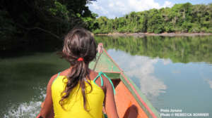 An indigenous girl navigates the Xingu River.