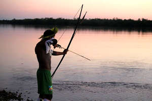 Indigenous Man Bow Fishing on Xingu River