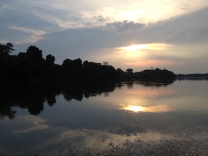 The sun sets over the Xingu River in the Amazon.