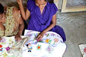 A women hand stitches a beautiful design
