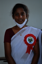 Anusha poses with her program completion ribbon