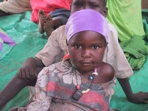 IDP youth waiting with her mother outside Tawilla