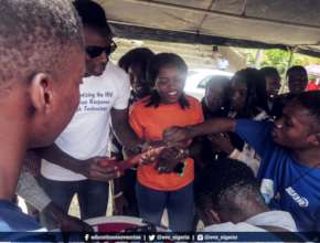 A student demonstrating how to use the male condom