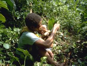 Giving baby water in the forest