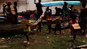 Children helping unload PUR water sachets