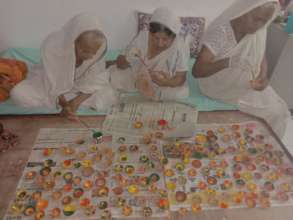 Mothers making Diyas
