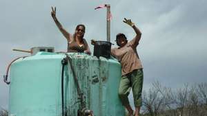 Uma and Jamie cleaning out the water tank