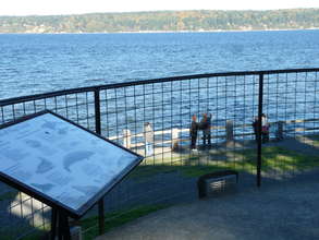 Whale watchers at Whale Bell Park as orcas pass by