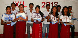 Graduating youth proudly hold their diplomas