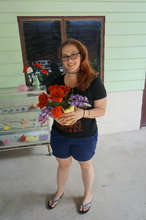 student purchasing flowers from shop at center