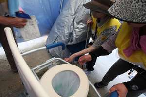 visually impaired participant examines a toilet