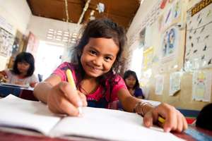 A kindergarten girl can smile when you feed her
