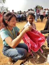 Giving backpacks full of school supplies