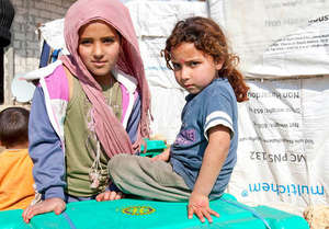 Refugee children with relief supplies
