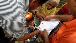 An old woman  signing  using her  finger print