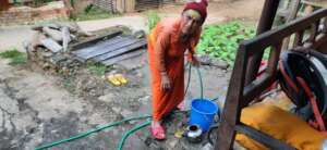 An old age woman filling her water pot