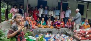 People waiting   to receive food materials .