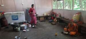 A cook  ( woman ) in the kitchen.