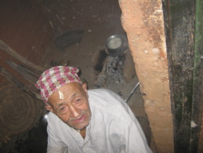 An old age man in the kitchen